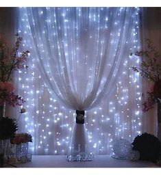 the curtains are decorated with lights and flowers