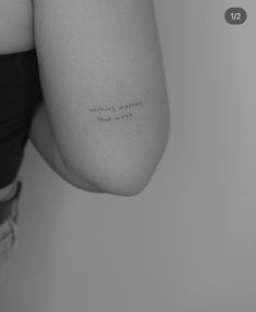 the back of a woman's shoulder with writing on it that says, nothing is possible