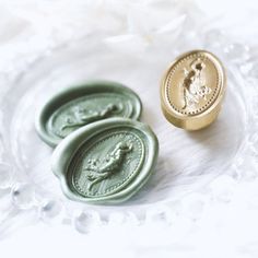 three wax seals sitting on top of a white table