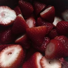 sliced strawberries are in a bowl on the table