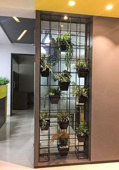 an office building with plants growing on the wall and in front of it is a glass door