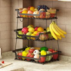 two tiered metal fruit basket with apples, oranges and bananas