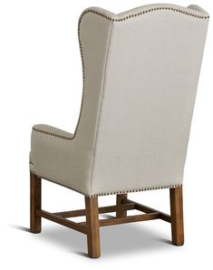 an upholstered chair with nail - tipped trimmings