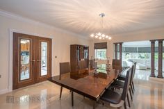 a dining room table and chairs in front of sliding glass doors