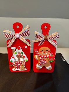 two red tags decorated with ginger cookies and candy canes