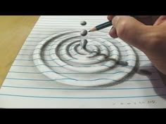 someone is drawing a spiral design on paper with colored pencils and watercolor crayons