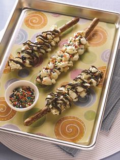 some kind of food that is on a tray with sprinkles and chocolate