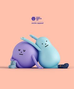 two blue and purple cartoon characters laying on the ground with their arms around each other