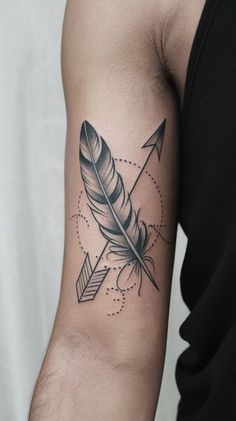 a man's arm with a feather and arrow tattoo on the left side of his arm