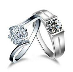 two white gold wedding rings with diamonds on each side and one diamond in the middle