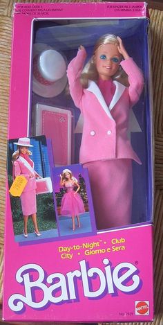 the barbie doll is wearing a pink suit and hat with matching shoes in its box