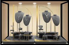 two display cases with necklaces and chairs