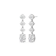 These diamond danglers exude a sense of sophistication and ease. They look relaxed and refined at once with their linear design and subtle movement. Each earring features a trio of round diamonds set in a vertical row and punctuated by a larger oval-cut diamond at the end. This elegant pair is the perfect choice when you want to dress to impress yet still be comfortable. Diamond Danglers, Round Diamond Setting, Dangler Earrings, Linear Design, Oval Earrings, Solitaire Earrings, Gorgeous Engagement Ring, Oval Earring, Oval Cut Diamond