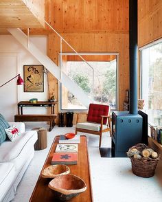 a living room filled with furniture and wooden walls