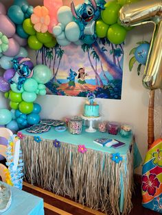 the table is set up with balloons, decorations and other items for a little mermaid birthday party