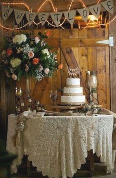 a table with a cake and flowers on it