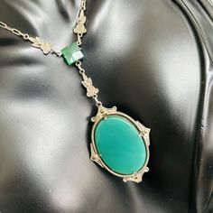 This original 1920s Art Deco Y-necklace features gorgeous green Chrysoprase set in a finely detailed Sterling Silver frame. A few strategically placed marcasites add extra sparkle! The piece is in PHENOMENAL condition, free of damage to the stones and necklace. It even maintains it's original clasp, which is unusual for a piece of this age. The necklace is 15" long w a 3 inch drop and weighs 9.7 grams. You will notice that the color of chrysoprase, which is a variety of quartz, shows differently Antique Oval Cabochon Gemstone Necklaces, Art Deco Oval Necklace For Formal Occasions, Green Oval Necklace For Formal Occasions, Formal Oval Art Deco Necklace, Formal Green Oval Necklace, Formal Art Deco Oval Necklace, Vintage Gemstone Necklace With Oval Cabochon, Antique Green Necklaces For Weddings, Elegant Green Chrysoprase Necklace