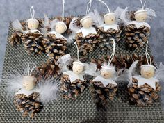 pine cones with angel decorations on them