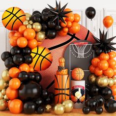 an arrangement of balloons, basketballs and other sports related items are arranged in the shape of a house