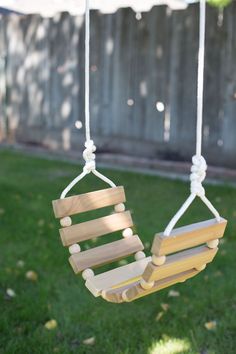 a wooden swing hanging from a rope