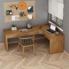 a computer desk with a laptop on top of it next to a chair and window