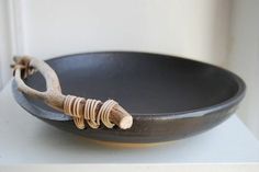 a black bowl sitting on top of a white counter