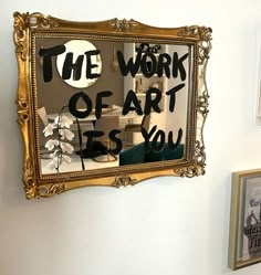 a mirror with the words the work of art is you written on it