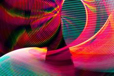 an abstract image with lines and colors in the form of circles on a black background