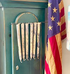 an old green cabinet with american flag hanging on it