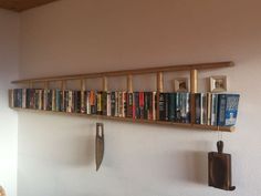 a bookshelf filled with lots of books on top of a wall