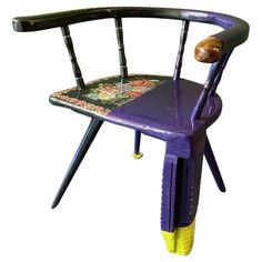 a purple and yellow chair with a snail on it's back end, sitting in front of a white background