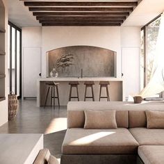 a living room filled with furniture next to a window covered in lots of windows and wooden beams