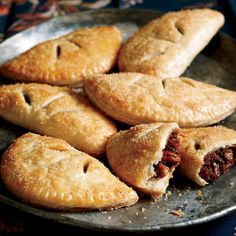 several pastries on a plate with a knife