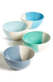 three different colored bowls sitting next to each other