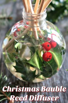 christmas bauble reed diffuser with holly leaves and red berries in a glass jar