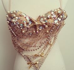 a white mannequin with lots of beads and chains on it's chest