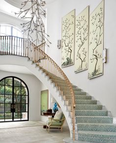 a staircase in a house with paintings on the wall