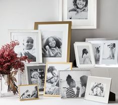 a table topped with pictures and vase filled with flowers