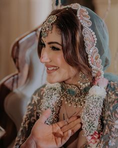 a woman wearing a veil and holding something in her hand