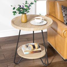 a small table with a cup of coffee on it next to a couch and chair