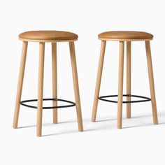 two wooden stools sitting next to each other