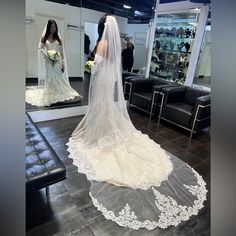 the bride is getting ready to walk down the aisle in her wedding dress and veil