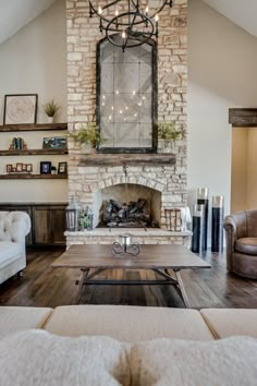 a living room filled with furniture and a fire place in front of a stone fireplace