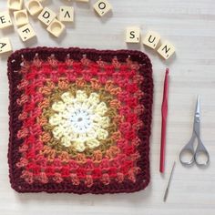 a crocheted square with the word sun spelled out