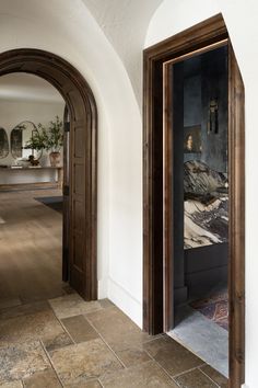 an open door leading into a room with white walls and wood trimming on the doors