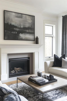 a living room filled with furniture and a fire place in front of a painting on the wall