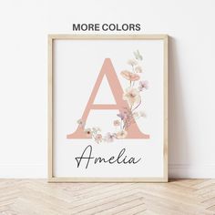 a frame with the letter a and flowers on it