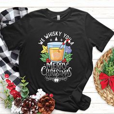 we whisk you a merry christmas t - shirt design with pine cones and holly