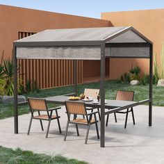 an outdoor table and chairs under a canopy