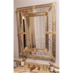 an ornate gold framed mirror in a bathroom